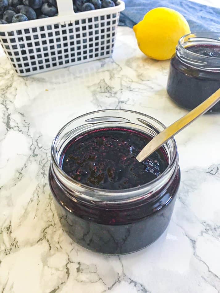 jar of blueberry chia jam with spoon inside