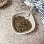 chia seeds and water in small white bowl