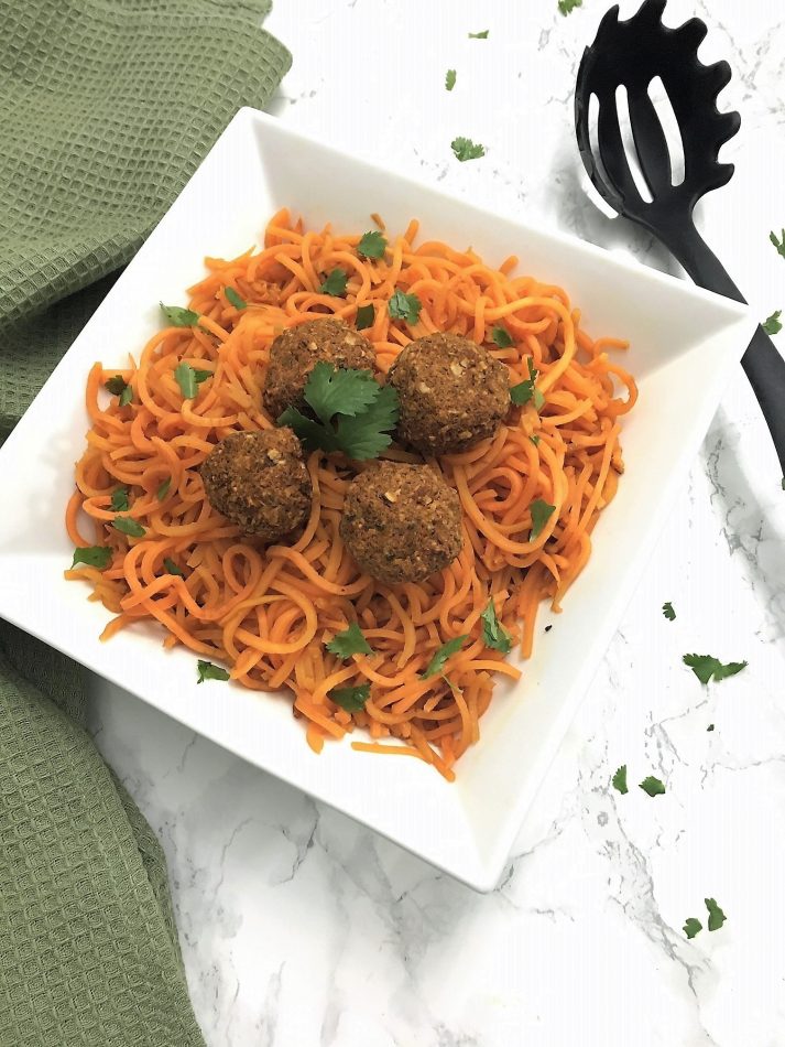 sweet potato noodles with lentil balls garnished with fresh cilantro