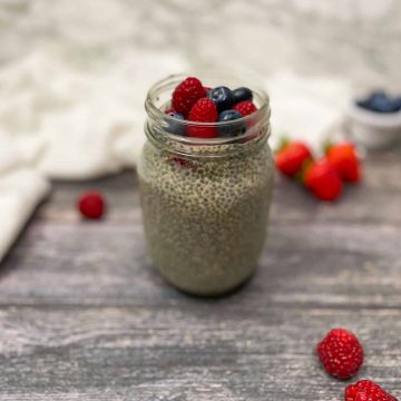chia pudding in glass mason jar with fresh berries on top