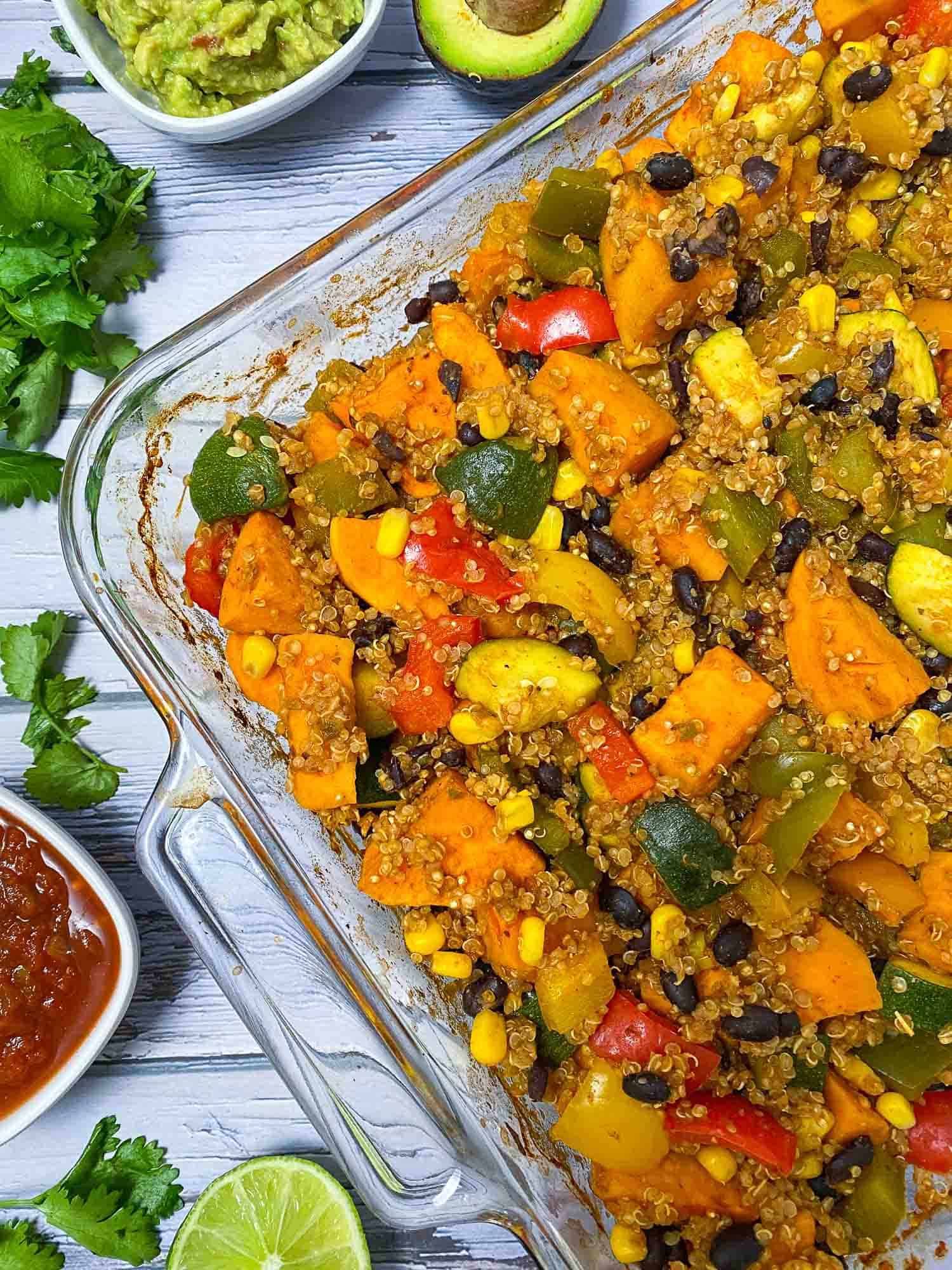glass dish with cooked sweet potato, peppers, zucchini, corn, black beans and quinoa