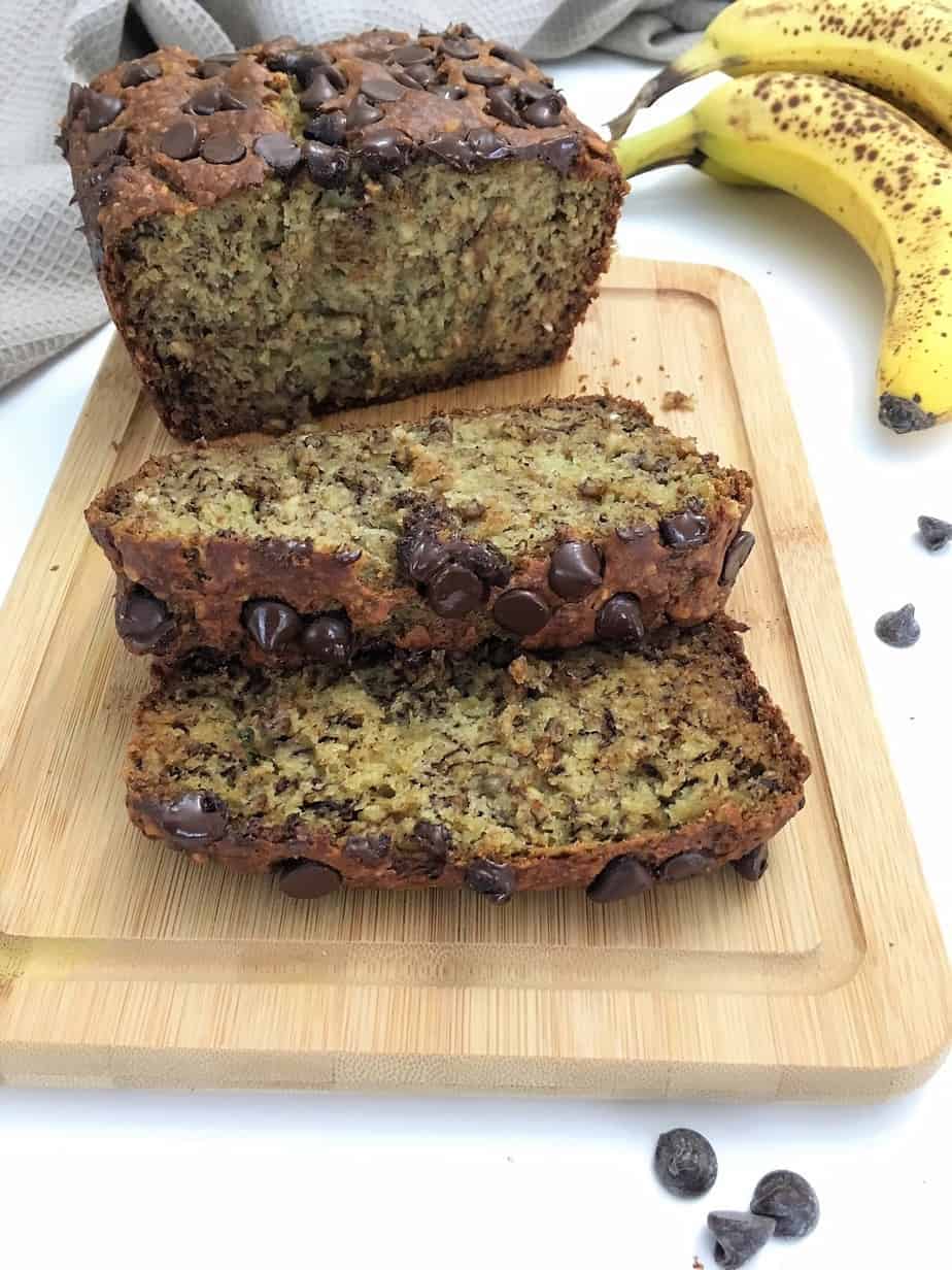 banana bread loaf on cutting board with two slices