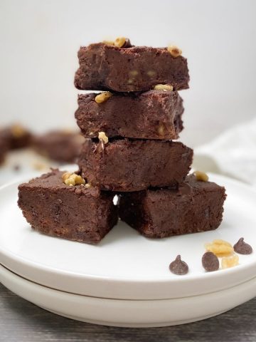 chickpea brownies on plate in a stack 4 high