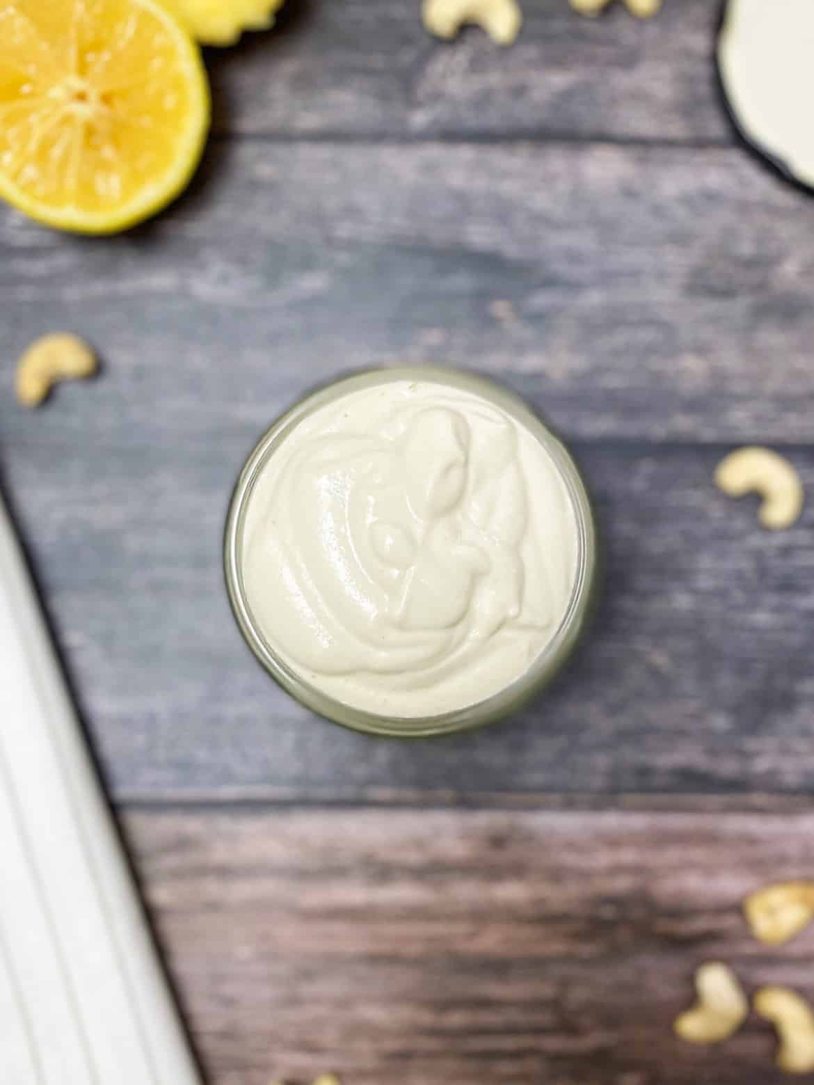 dairy free sour cream with cashews scattered around the jar