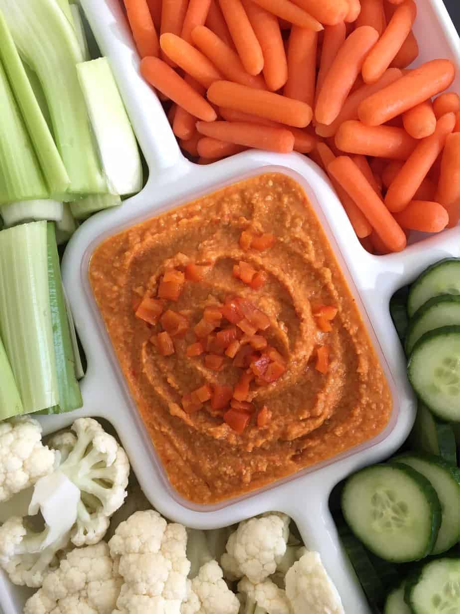 Roasted red pepper hummus in center of veggie tray
