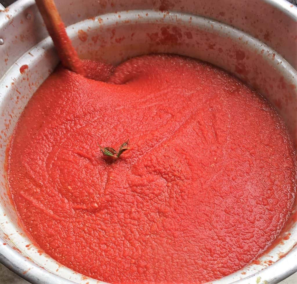 Tomato sauce cooking in large pot.