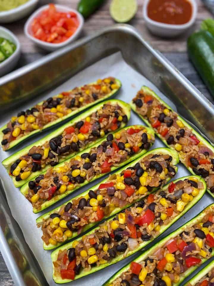 zucchini halves with taco stuffing in baking tray