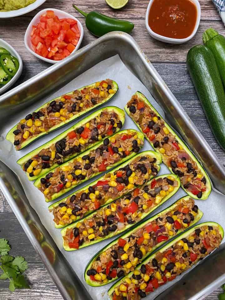 baked zucchini burrito boats in stainless steel baking tray