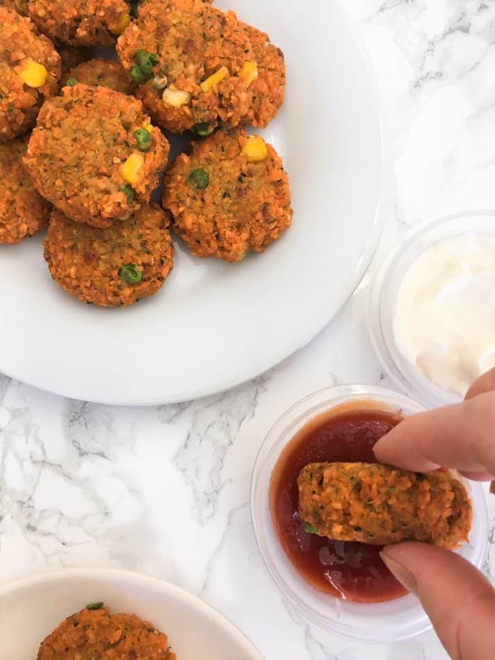 Lentil Veggie Nuggets dipping in ketchup