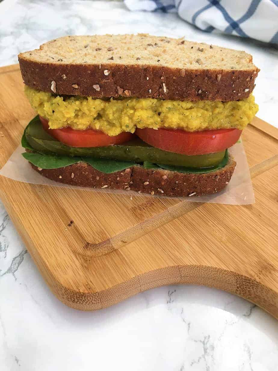 Chickpea Salad Sandwich with tomato, pickle, and baby spinach