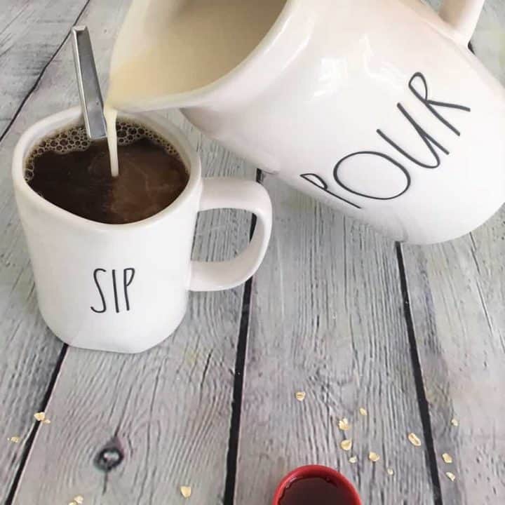 homemade oat milk pouring into coffee