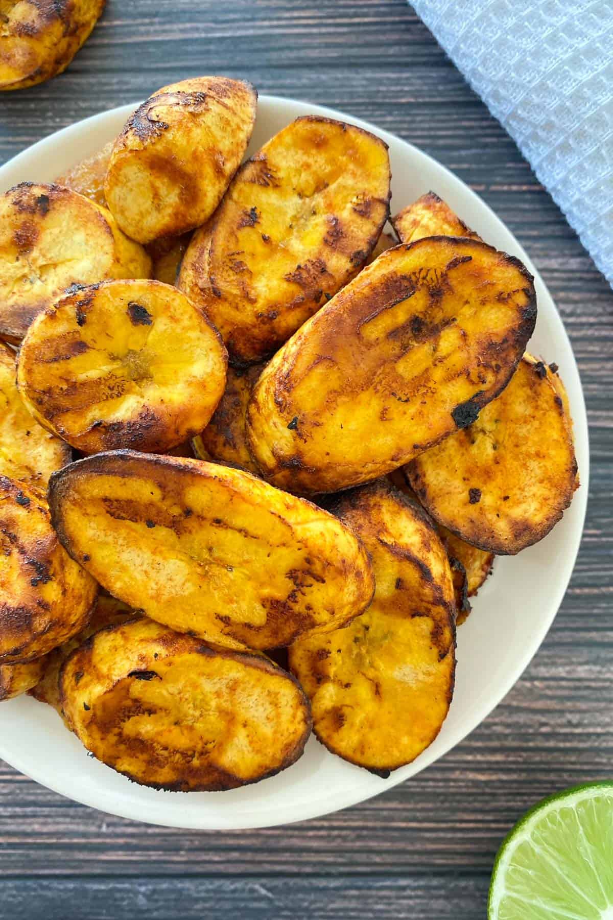 White plate with air fried plantain chips inside.