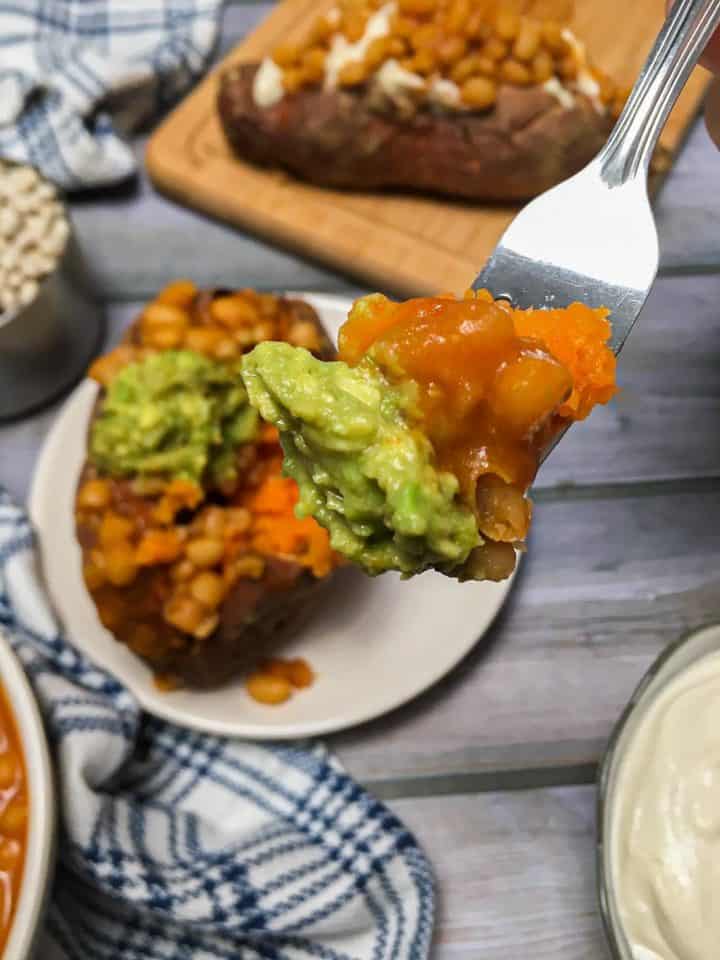 fork holding up bite of loaded sweet potato