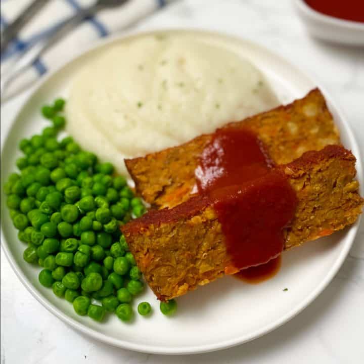 sliced vegan loaf with red sauce glazed on top