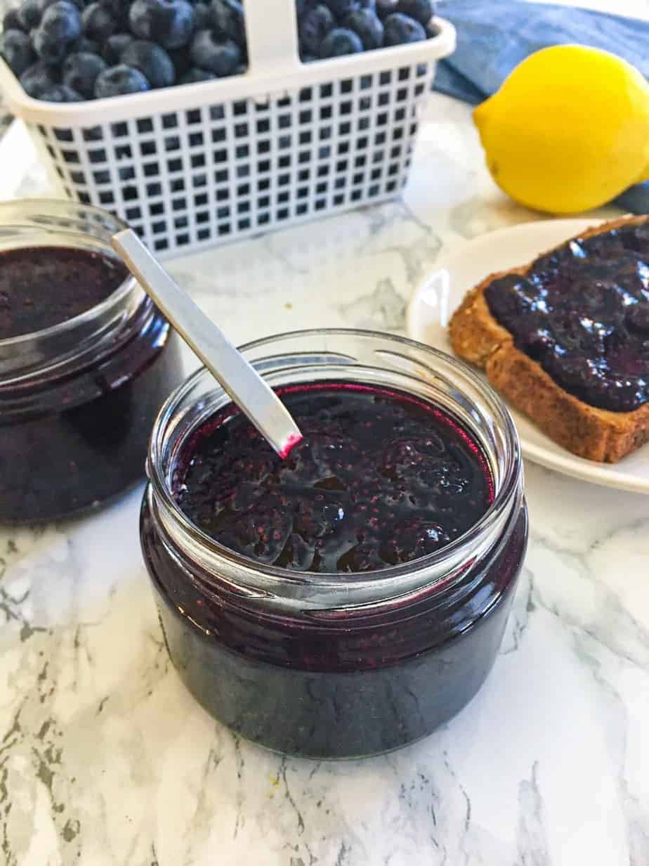 jar of blueberry chia jam with spoon inside