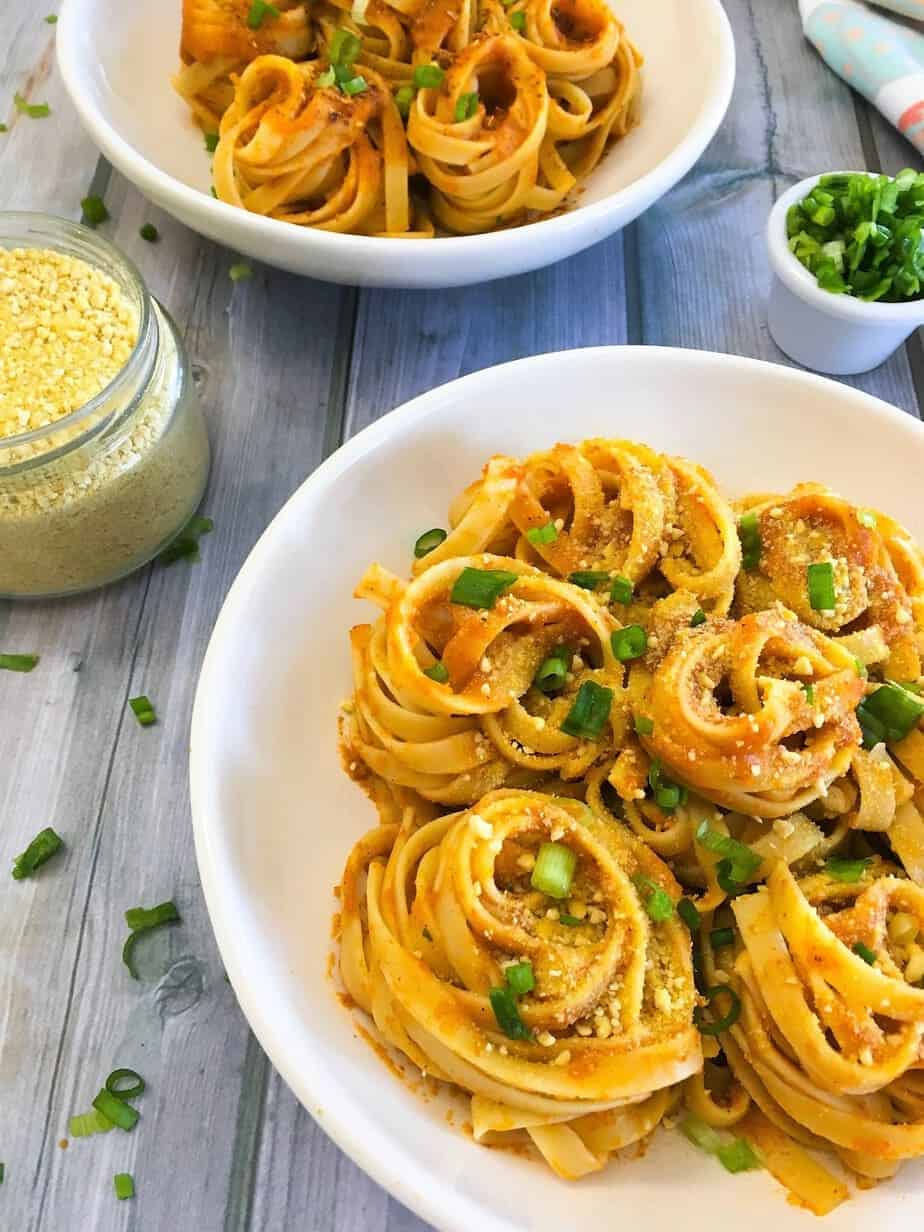 pumpkin pasta sauce over bowl of spaghetti twirls