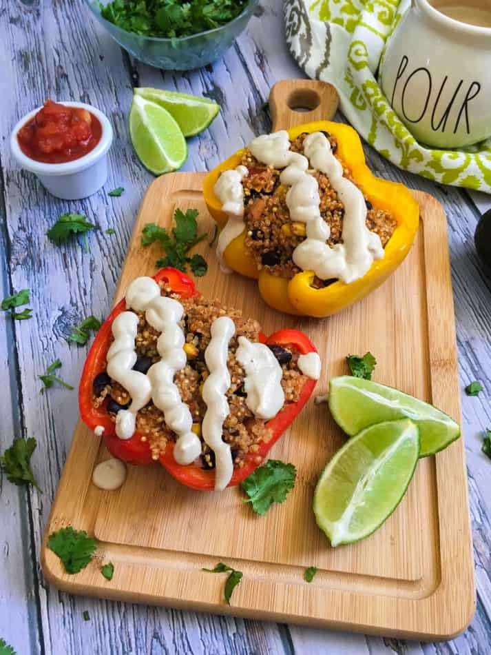 bell peppers cut in half and stuffed and topped with vegan queso