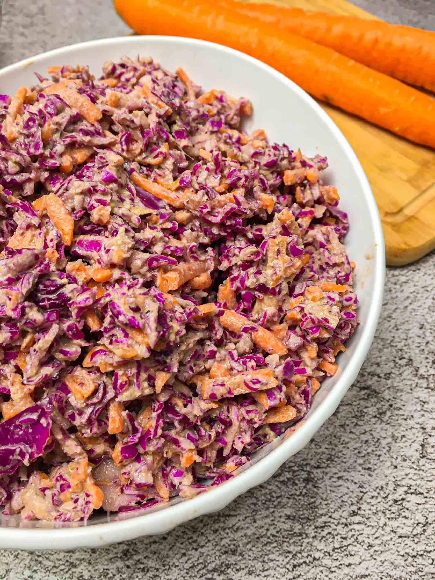 close up of white bowl with vegan coleslaw