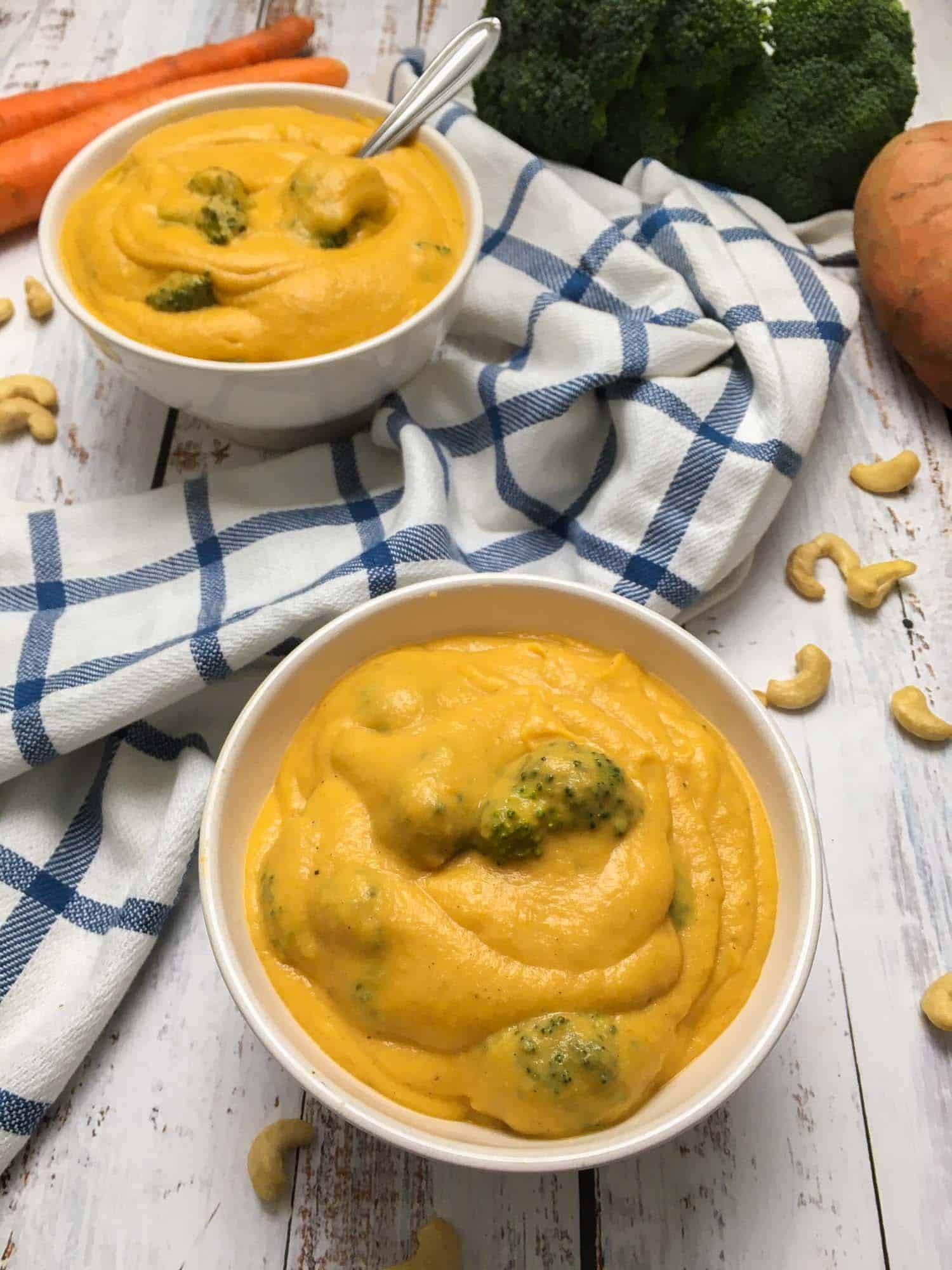 two bowls of broccoli cheese soup