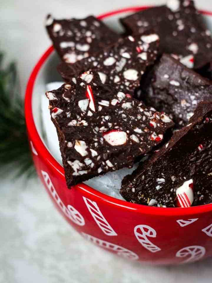 Chocolate peppermint bark in red bowl.