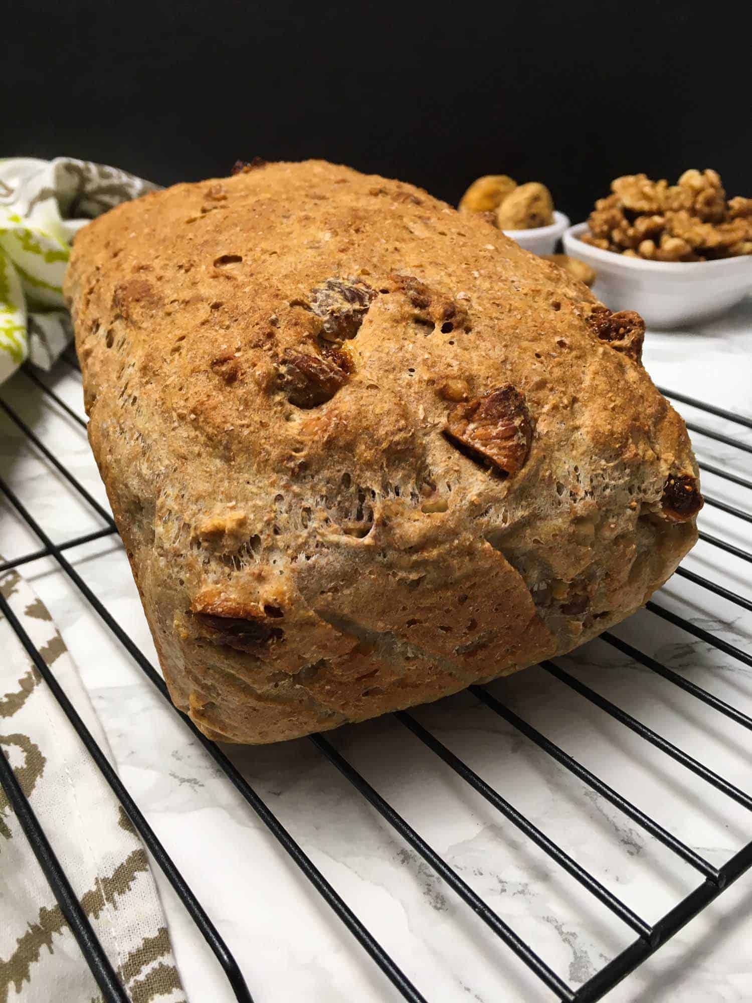 loaf of fig and walnut bread on cooling rack