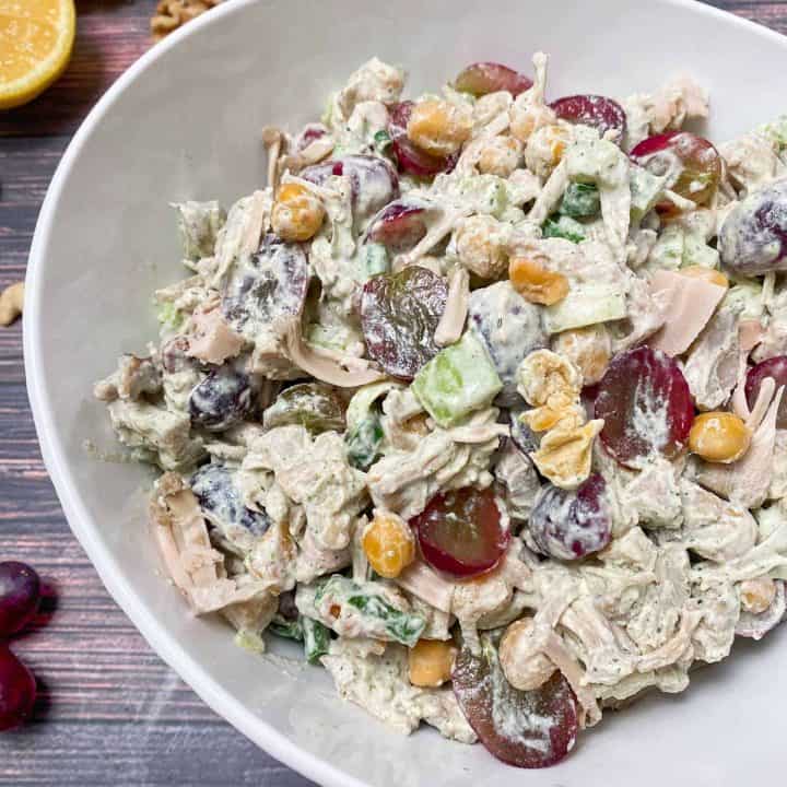 vegan chicken salad in white serving bowl with creamy dressing
