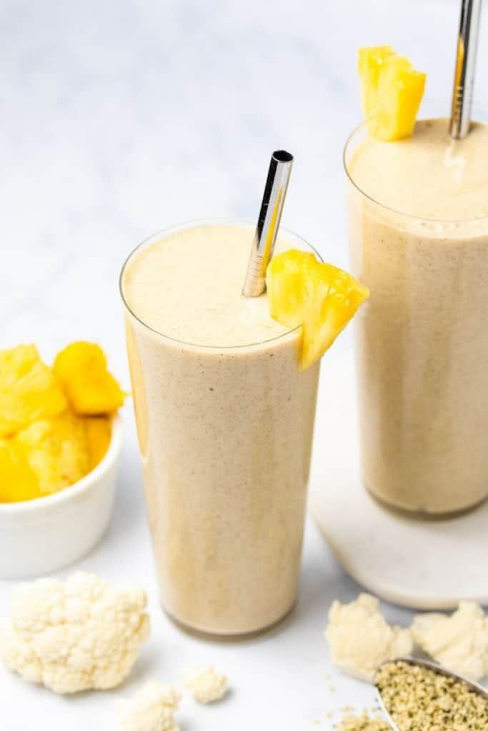 two glasses filled with banana cauliflower smoothie