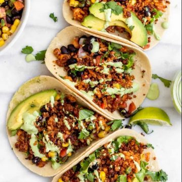 overhead view of tofu crumble tacos with avocado and lime garnish