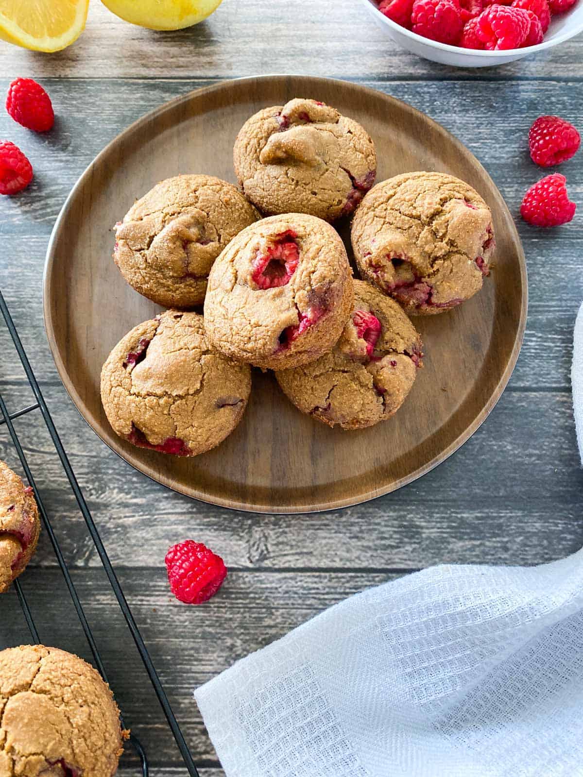 raspberry muffins stacked in a brown plate