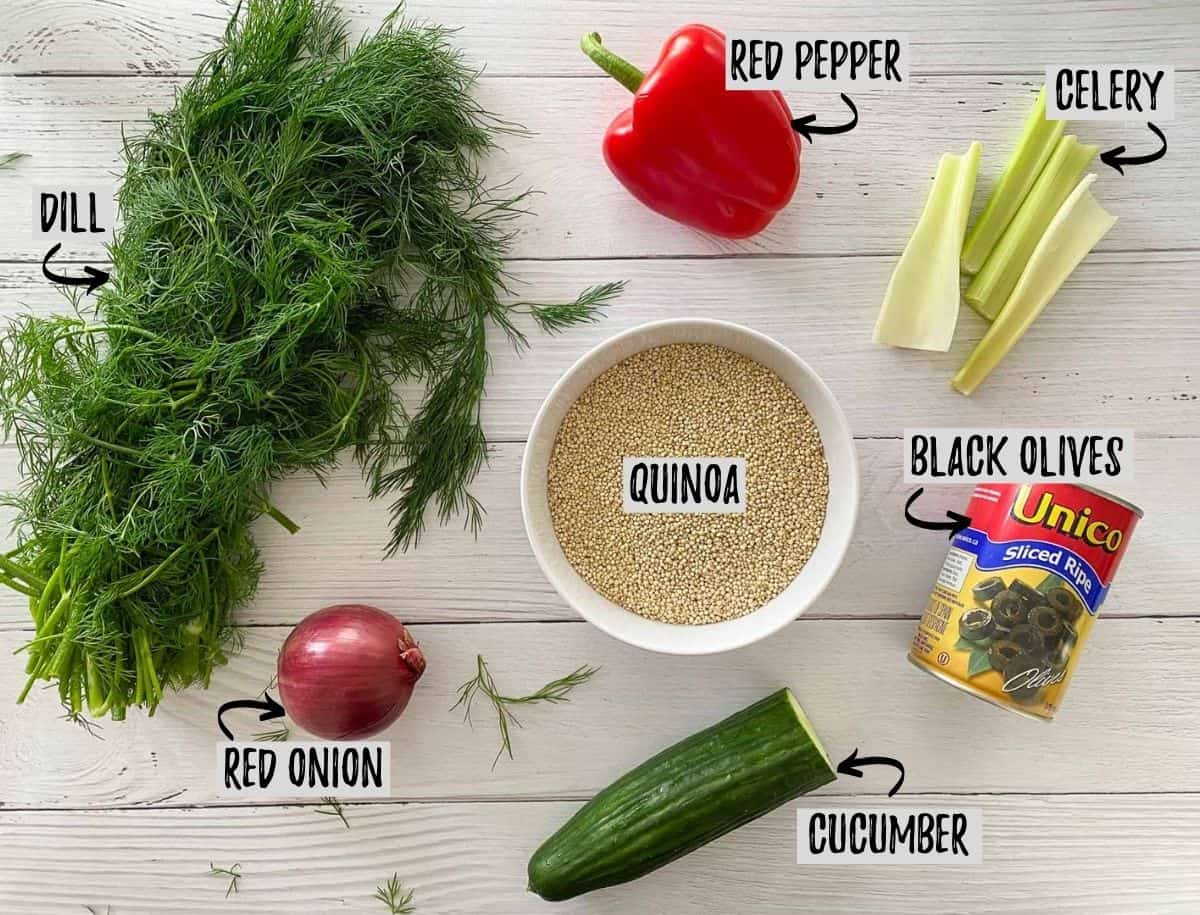 Ingredients to make quinoa pasta salad on white deck.