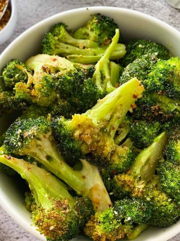 close up of bowl full of air fried broccoli
