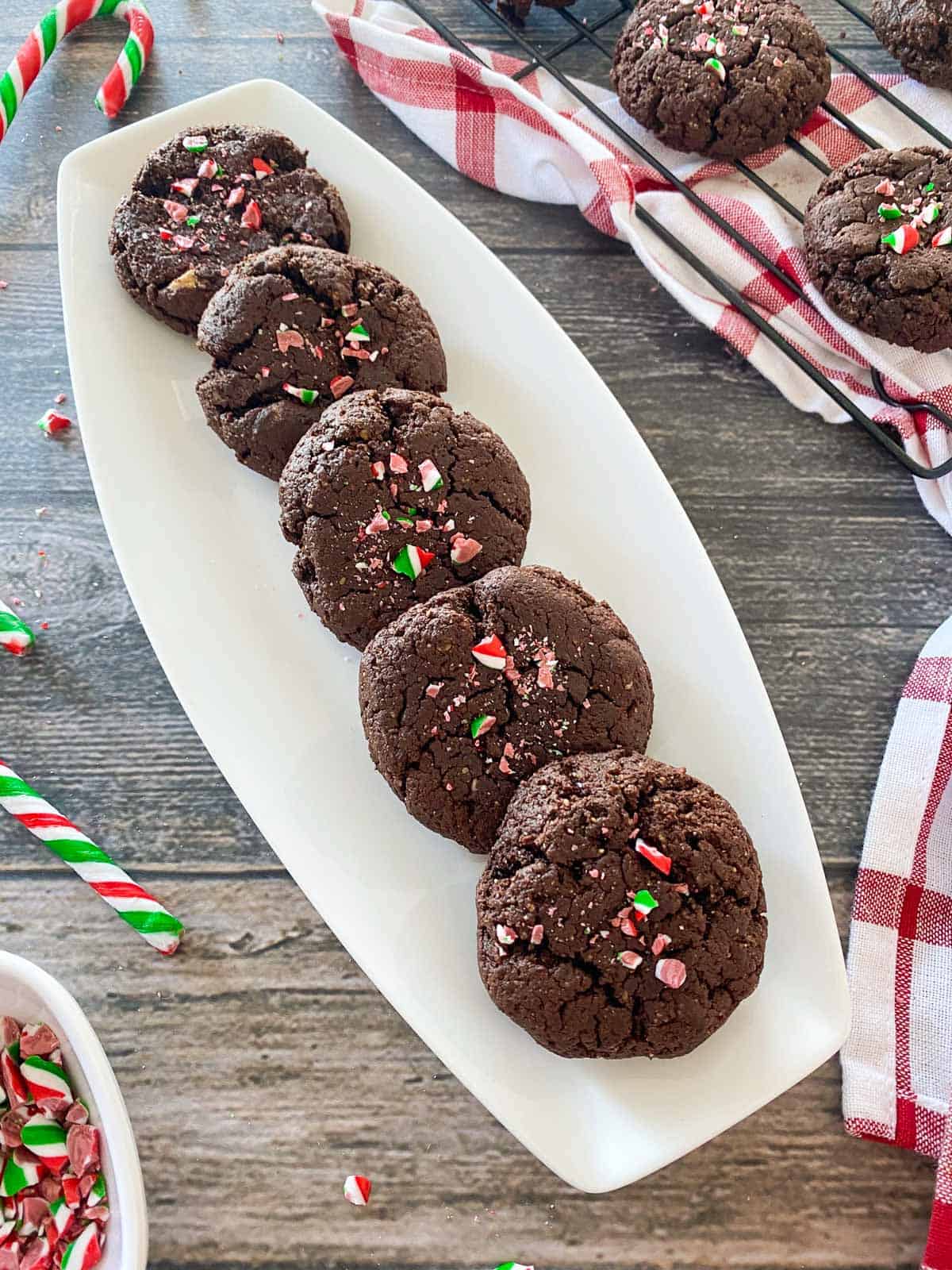 Brownie cookies in white serving dish with candy cane garnish.