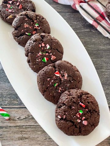 Brownie cookies in white dish with crushed candy cane on top.