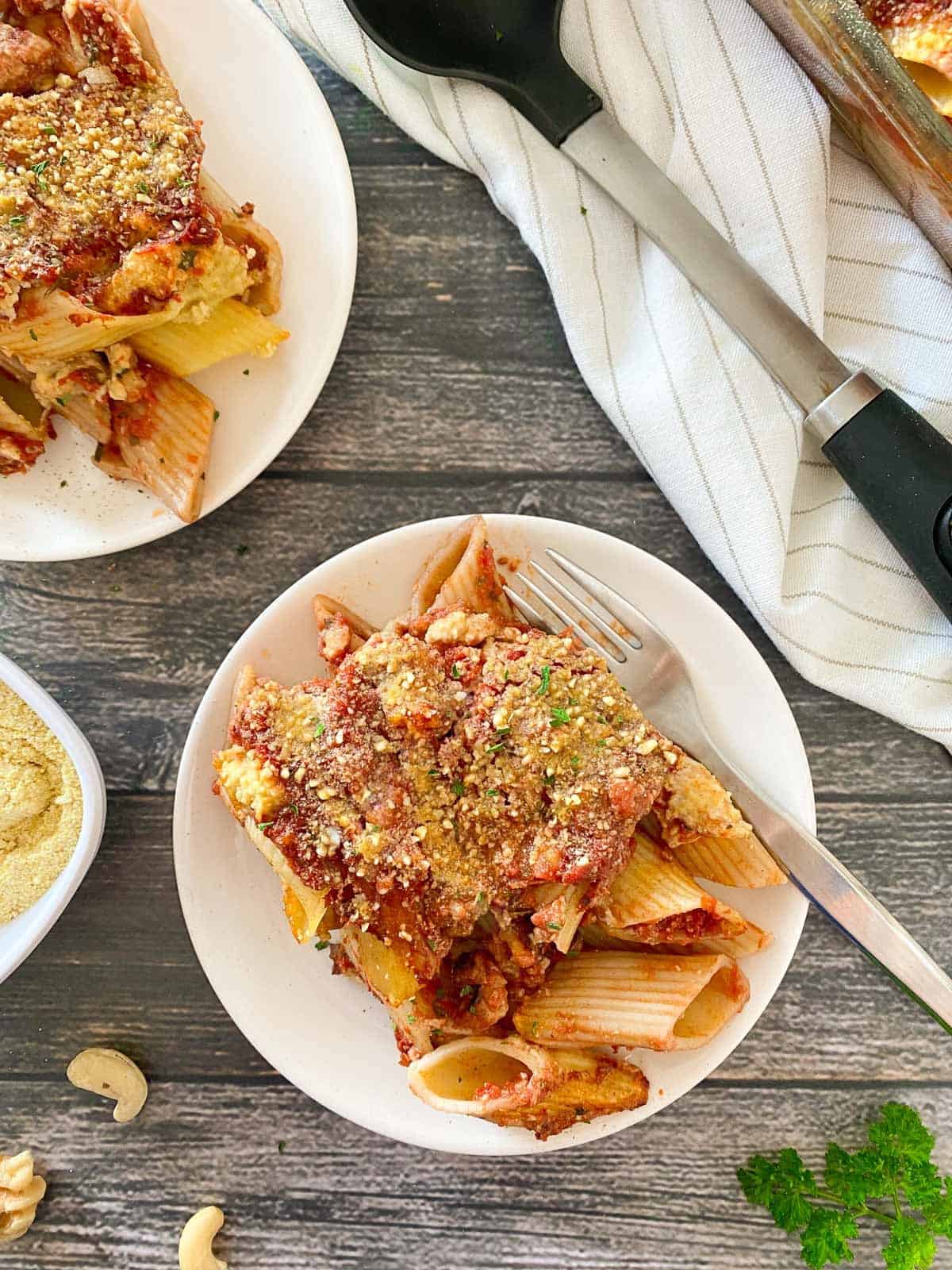 plate of baked pasta dish with fork inside.