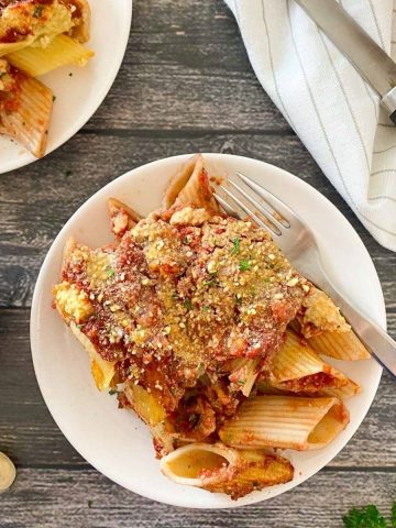 plate of baked pasta dish with fork inside.