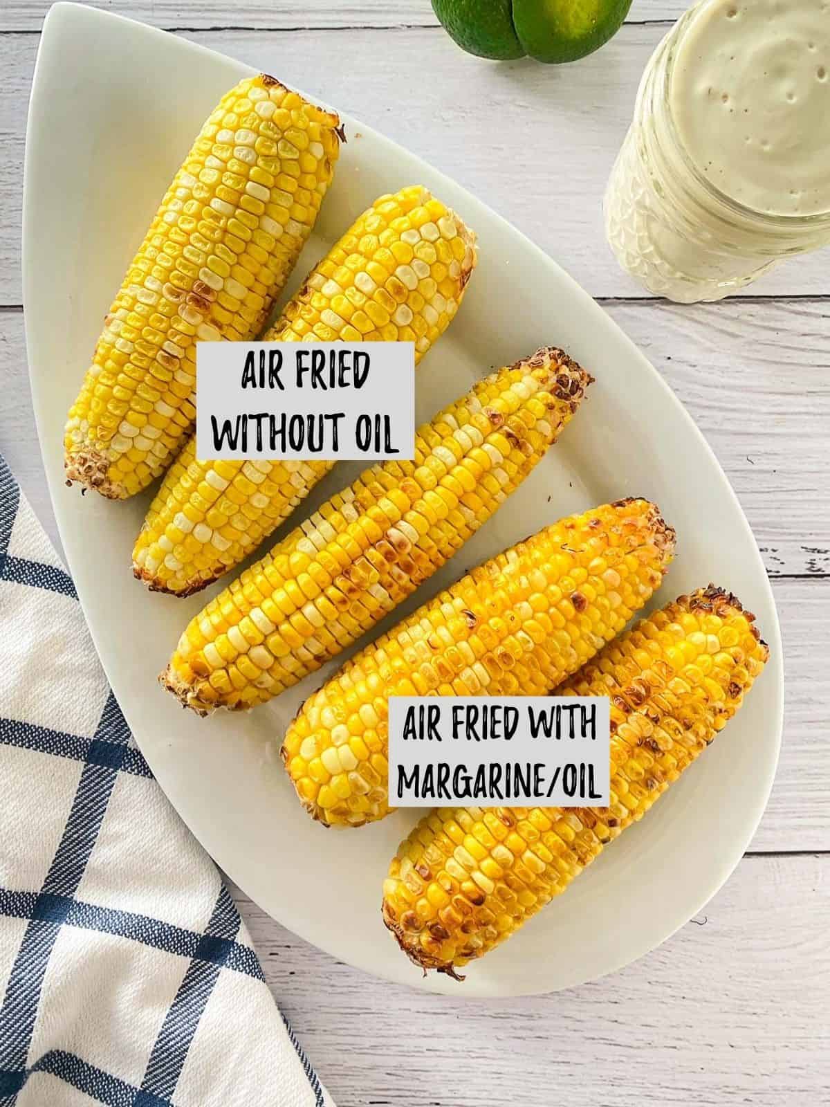 Platter with 5 corn on the cob on it with labels indicated which were made without oil vs. with oil.