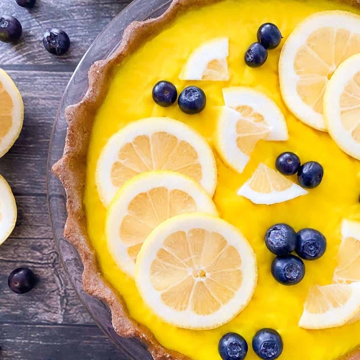 Close up of vegan lemon pie with lemon slices on top.