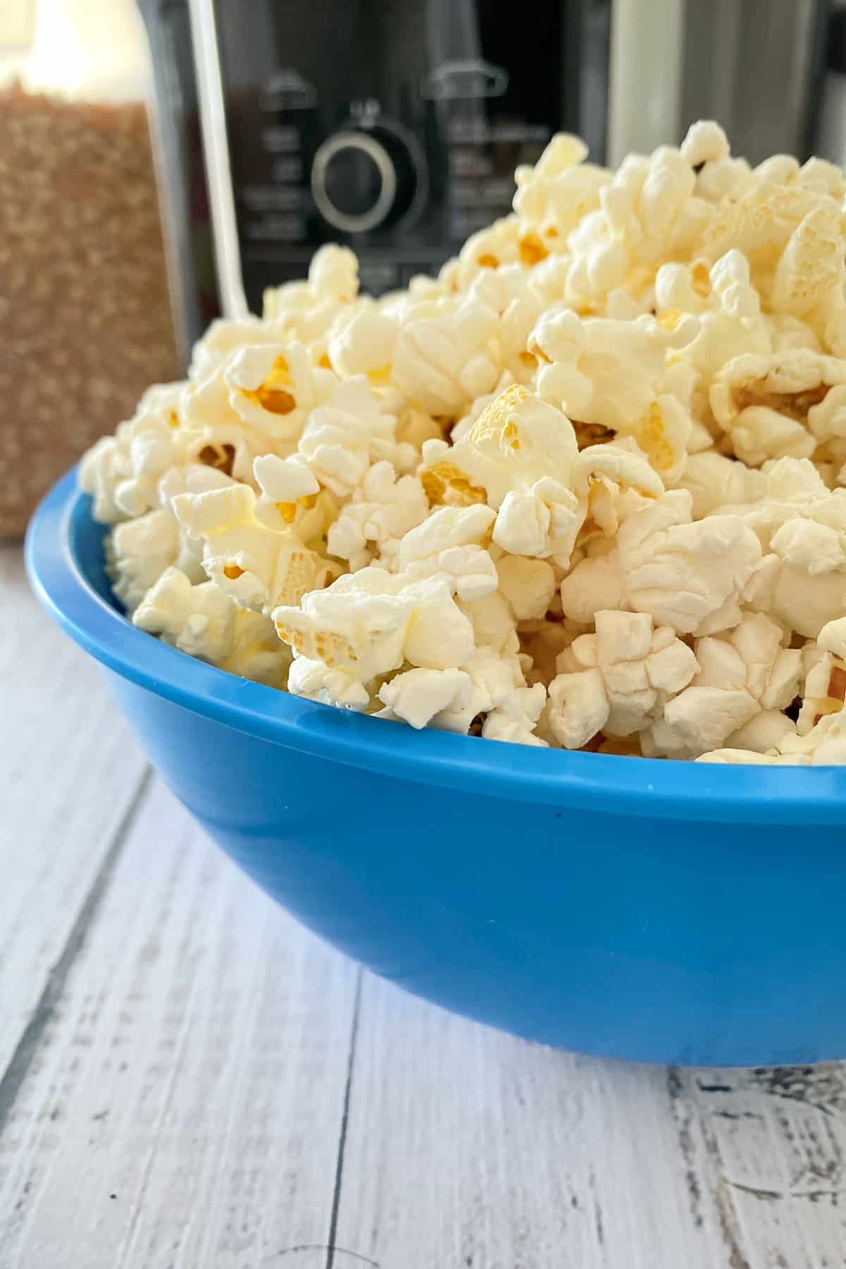 Blue bowl filled high with popcorn.