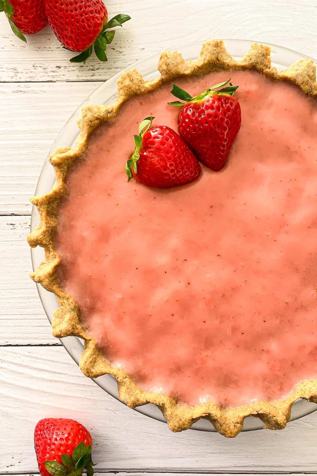 Close up of strawberry pie in pie plate.