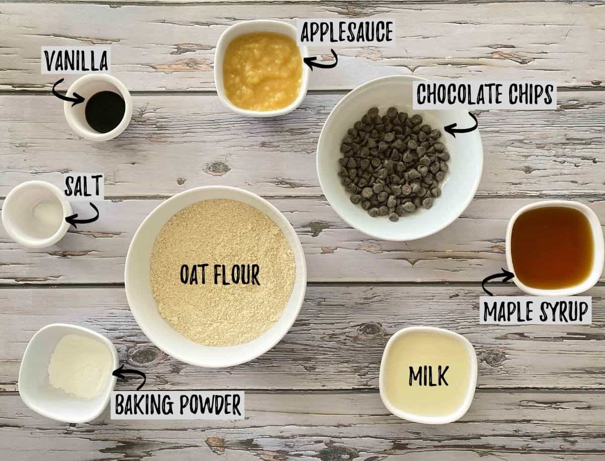 Ingredients needed to make cookies in separate small bowls on grey deck.