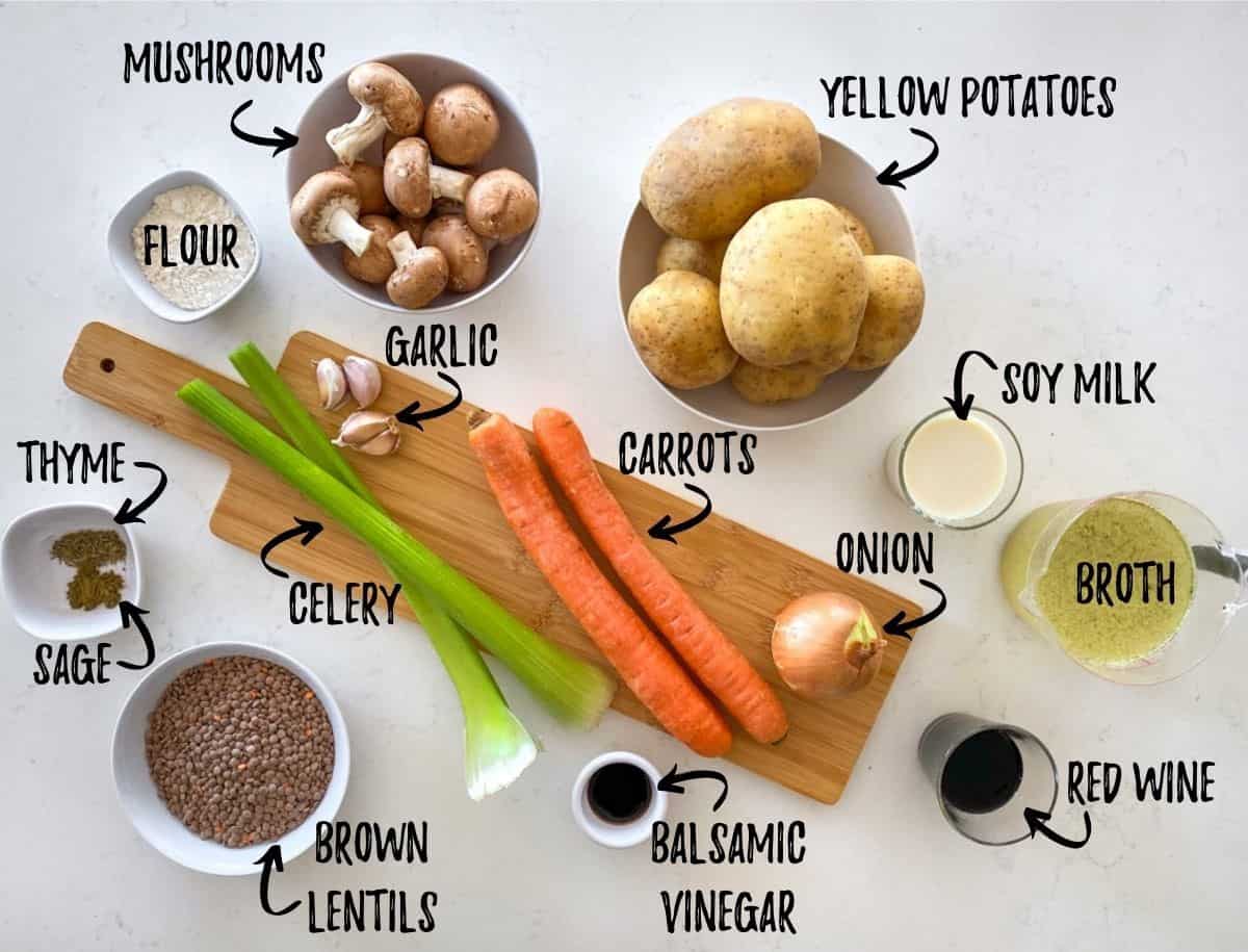 Ingredients needed to make vegan shepherd's pie scattered on kitchen counter top.