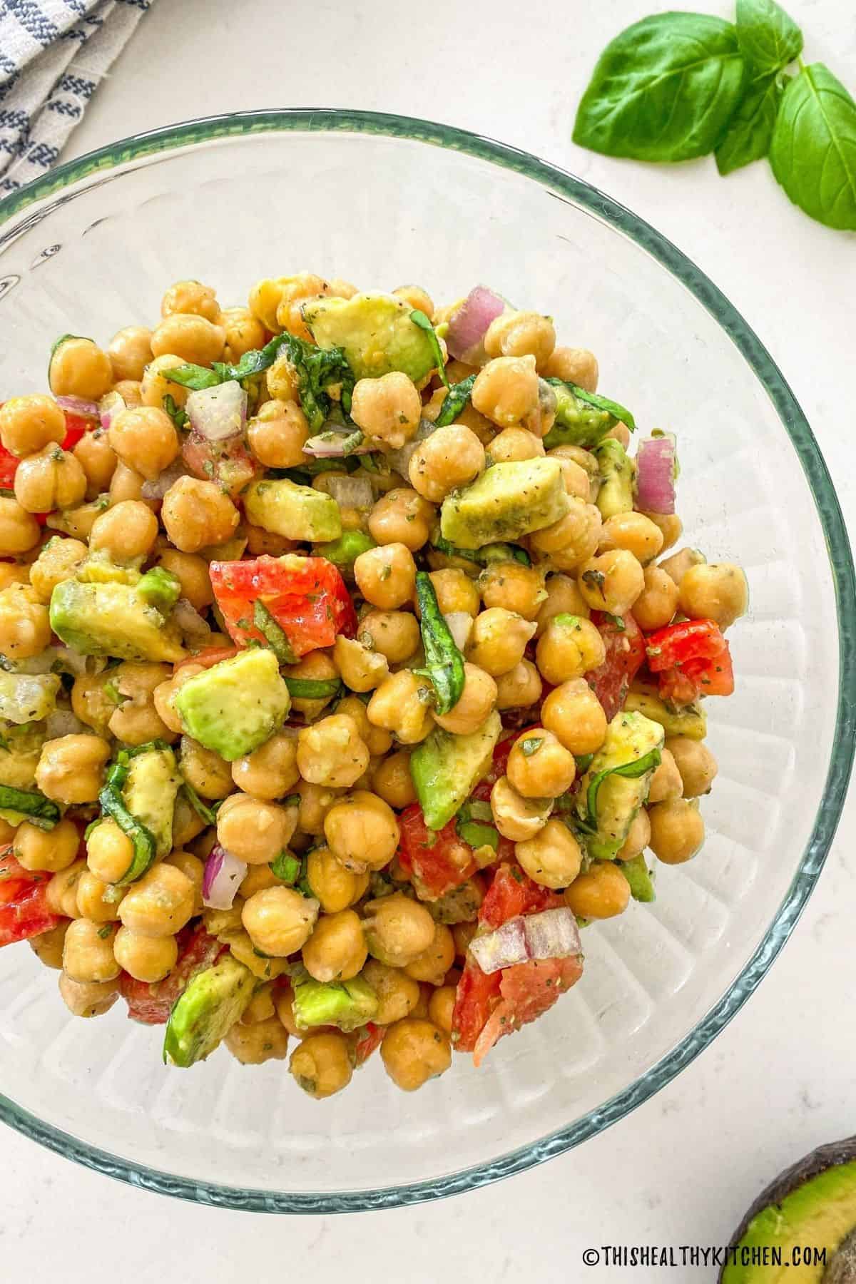 Chickpea salad in large glass mixing bowl.