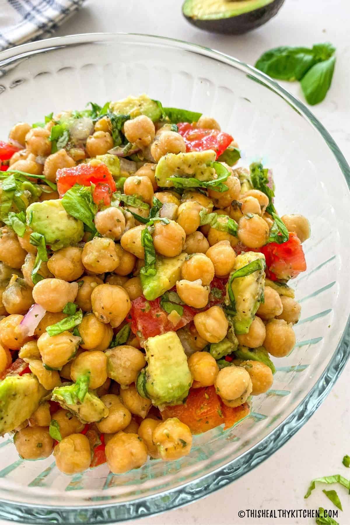 Glass bowl filled with chickpea salad.