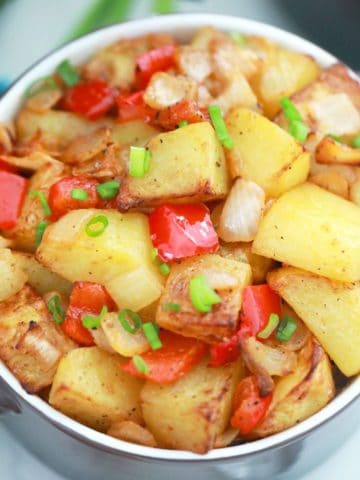 Air fried home fries inside purple serving bowl.