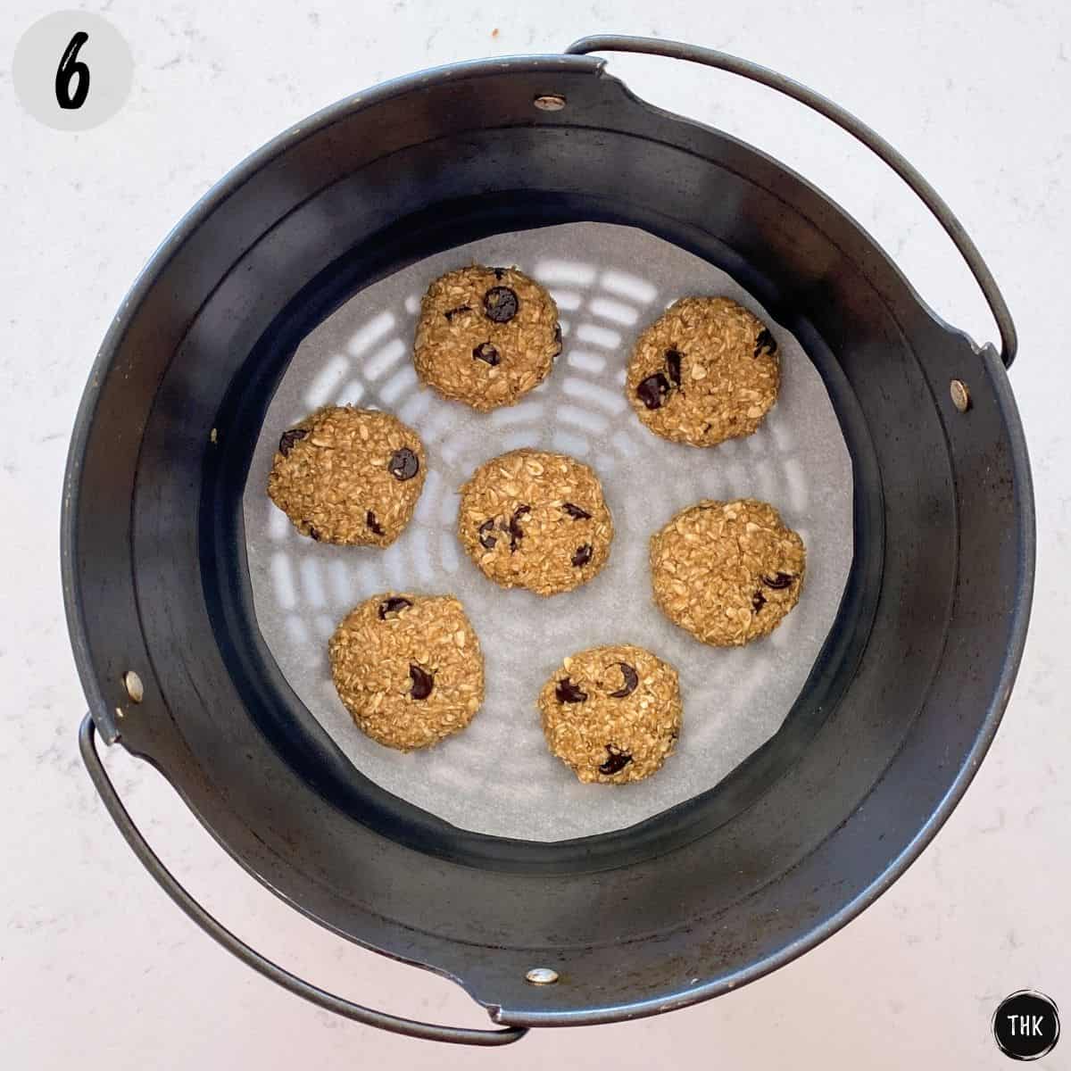 Cookies inside basket of air fryer.