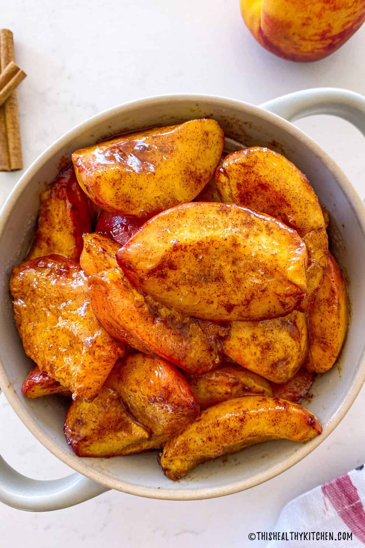 Air fried peach slices in serving bowl.