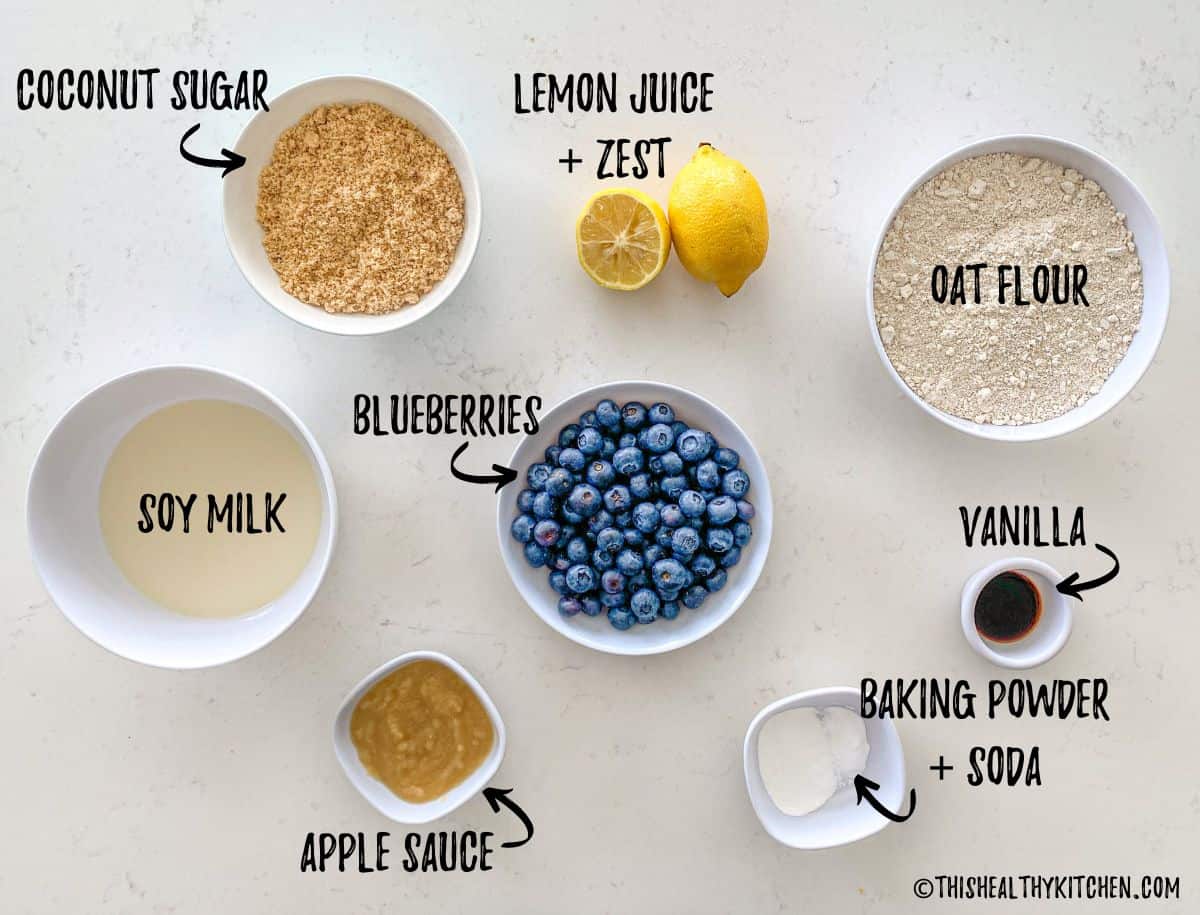 Ingredients needed to make lemon blueberry cake in bowls on kitchen counter.