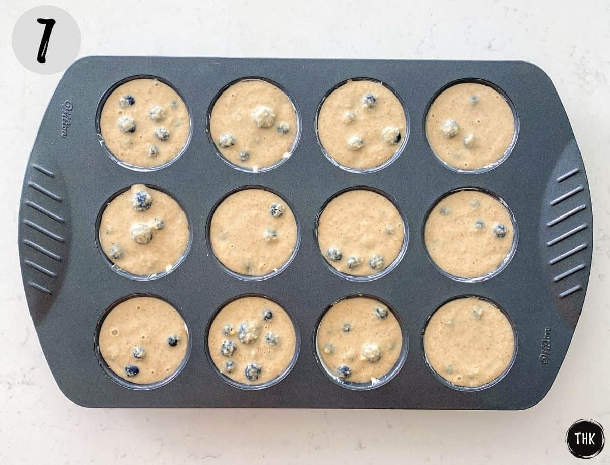 Blueberry muffins in muffin pan before baking.