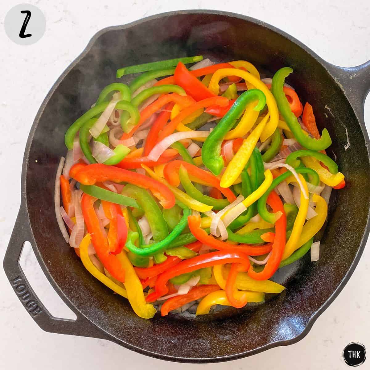 Sautéed peppers and onion in cast iron pan.