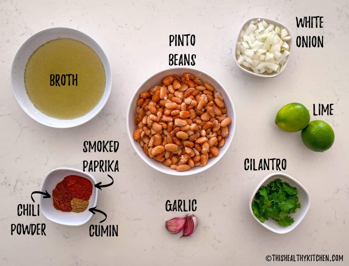 Ingredients needed to make oil free refried beans scattered on kitchen counter top.